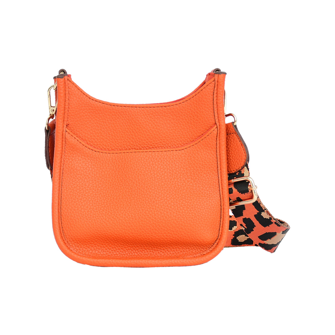 Orange handbag with a leopard print strap on a white background