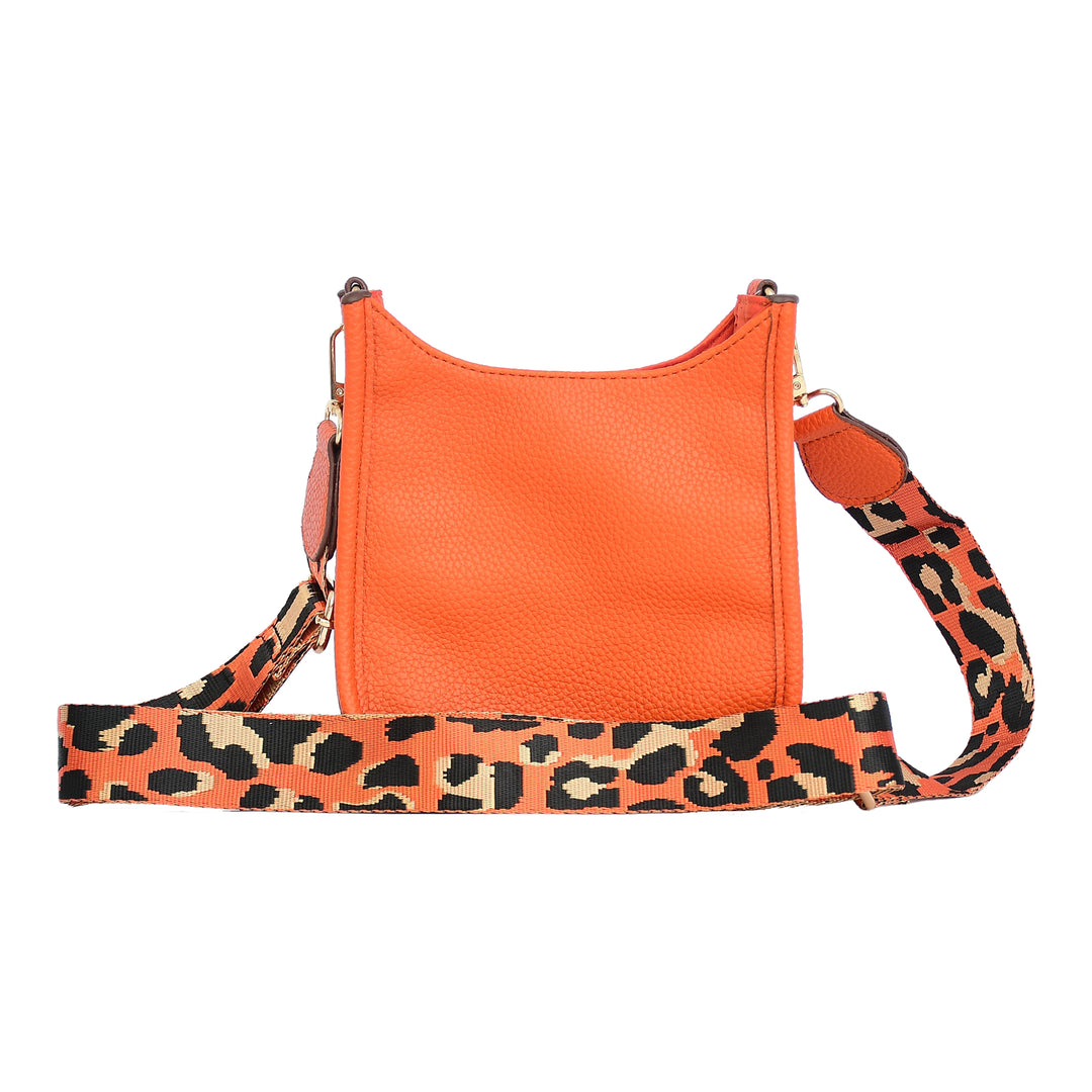 Orange handbag with a leopard print strap on a white background