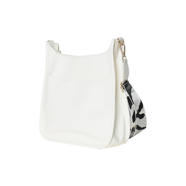 White handbag with a patterned strap on a white background
