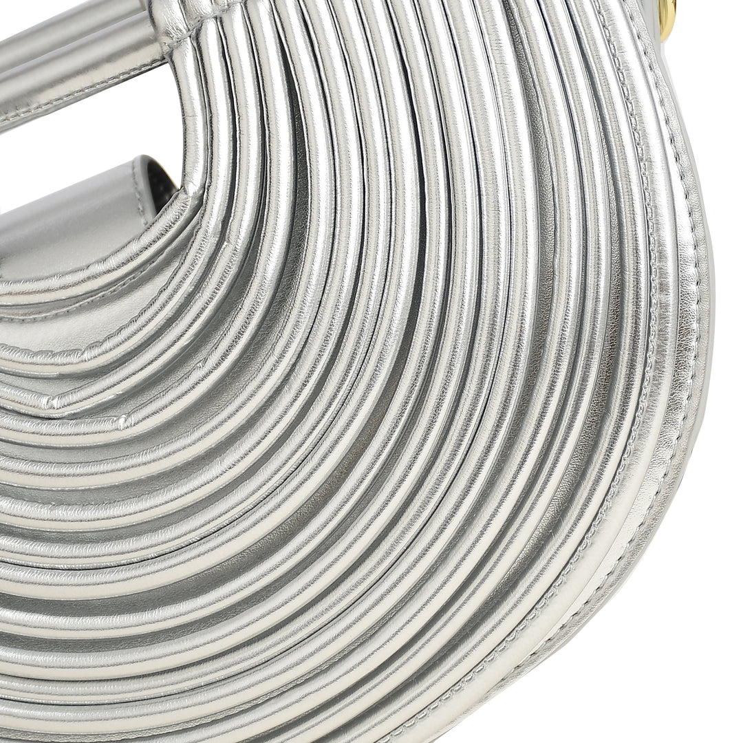 Close-up of a silver handbag with circular design