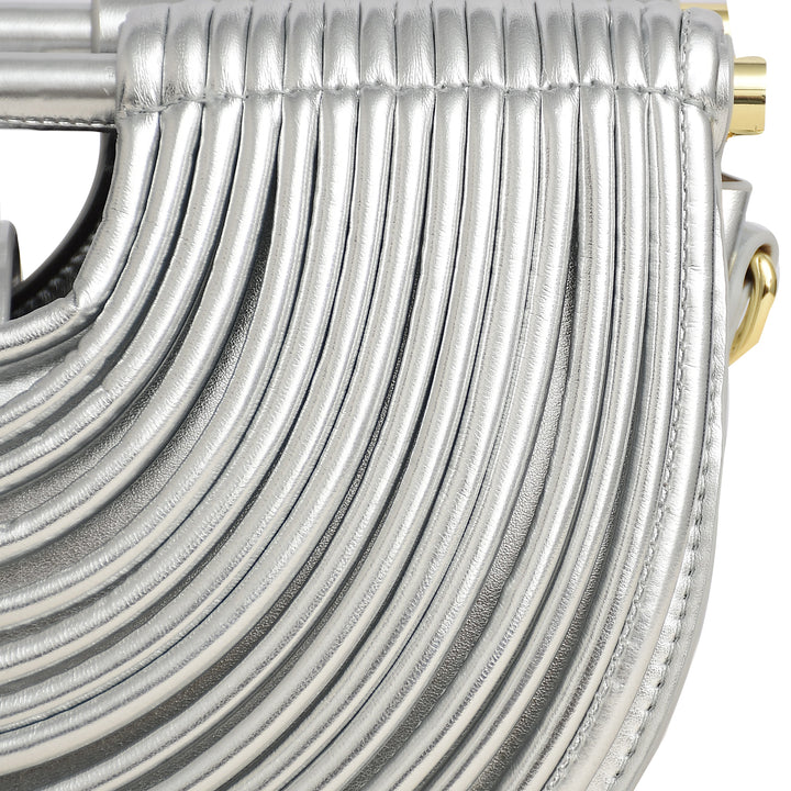 Close-up of a silver handbag with fringe detail on a white background