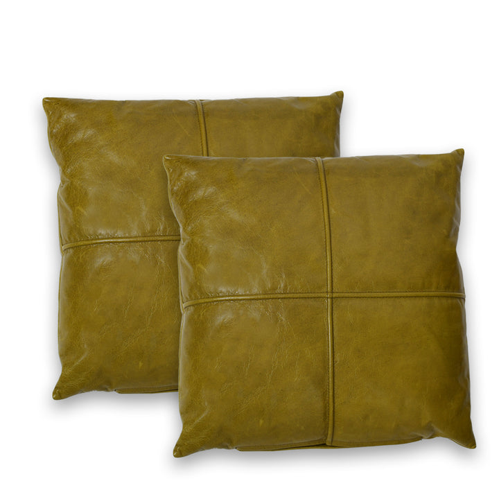 Two brown leather pillows on a white background

