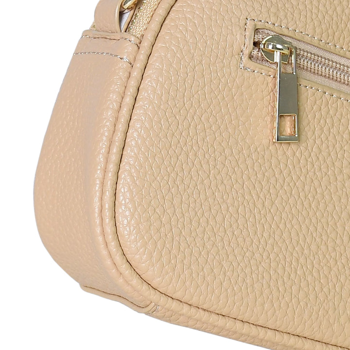 Close-up of a beige handbag with a gold zipper on a white background