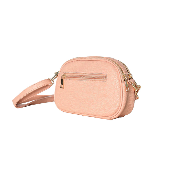 Pink crossbody bag with gold accents on a white background