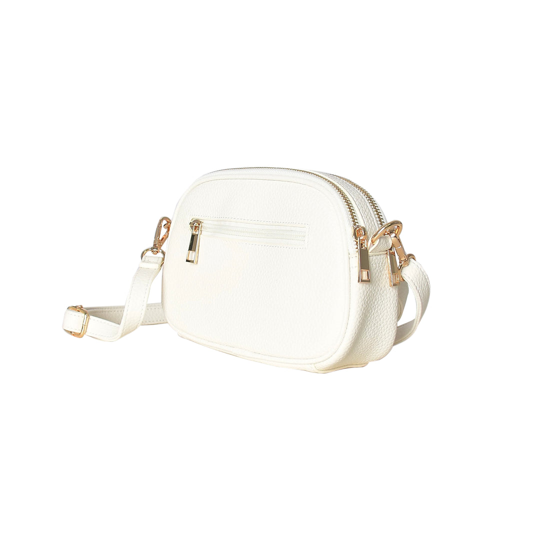White crossbody bag with gold accents on a white background