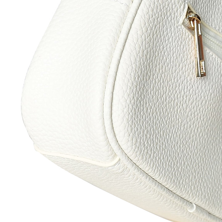 Close-up of a white textured handbag with a gold zipper.