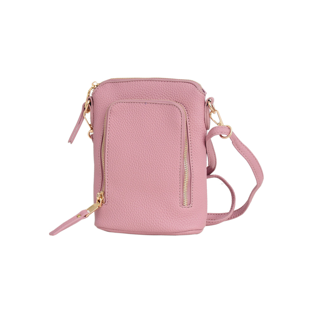 Pink crossbody bag with gold zippers on a white background