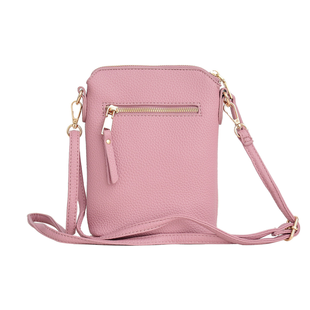 Pink crossbody bag with gold accents on a white background