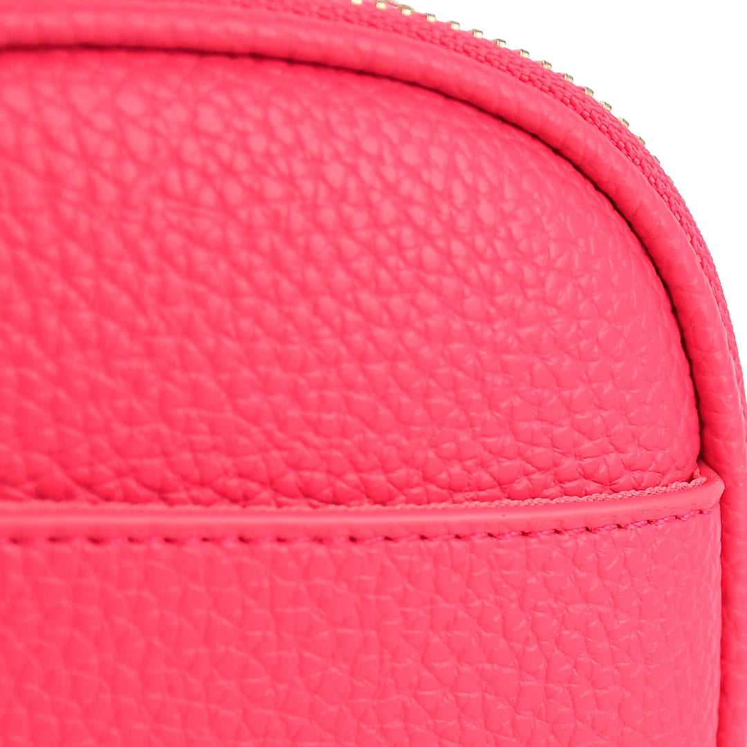 Close-up of a pink textured pouch with a zipper.