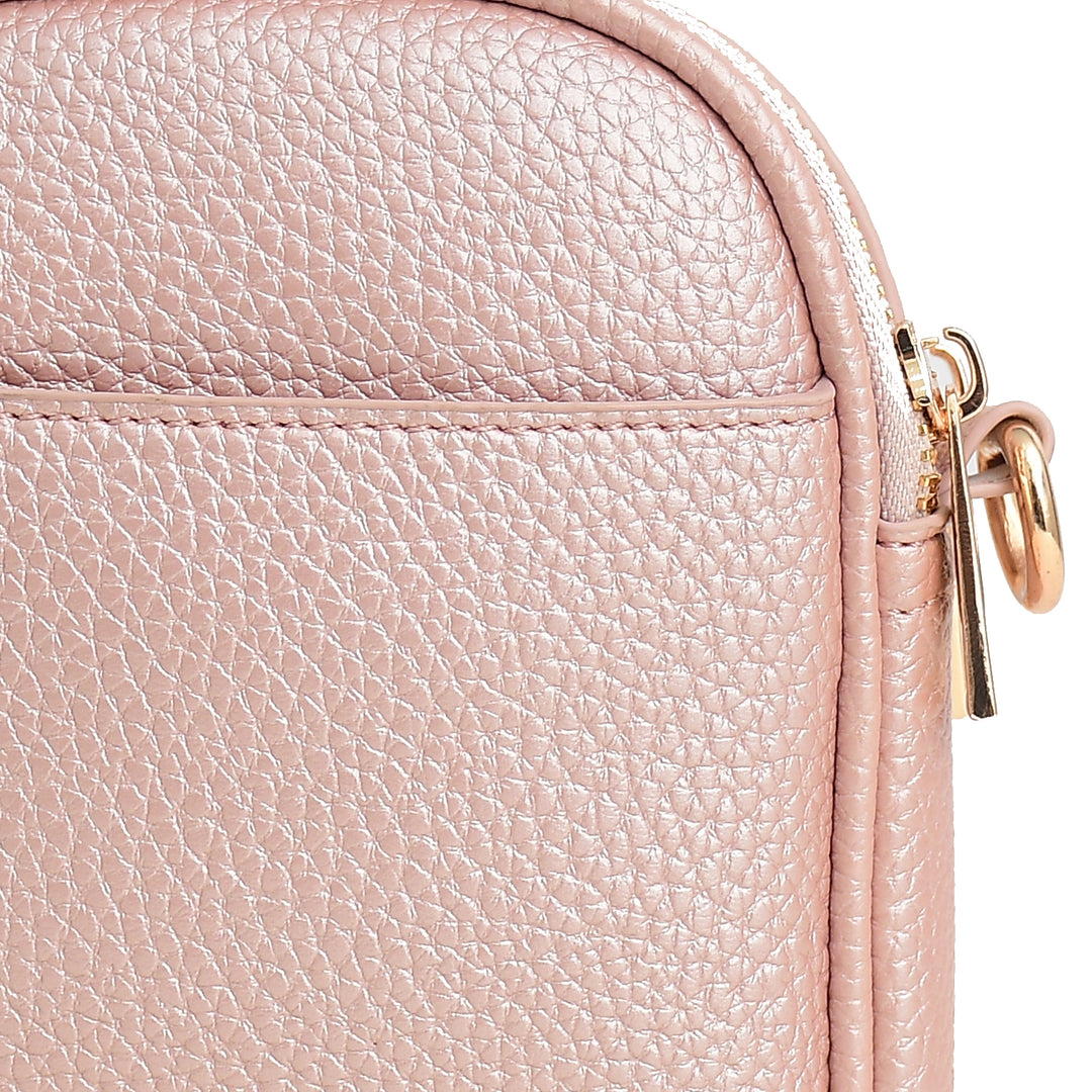 Close-up of a pink leather bag with a gold zipper.