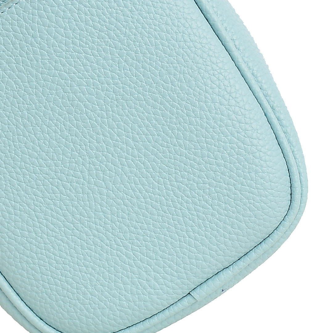 Close-up of a light blue leather product on a white background