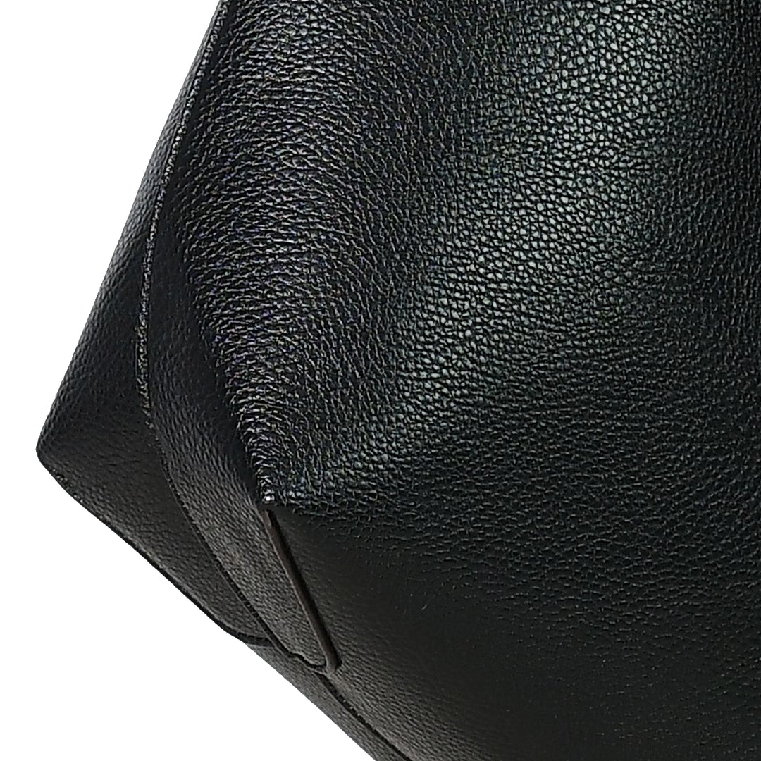 Close-up of a black leather bag with visible texture