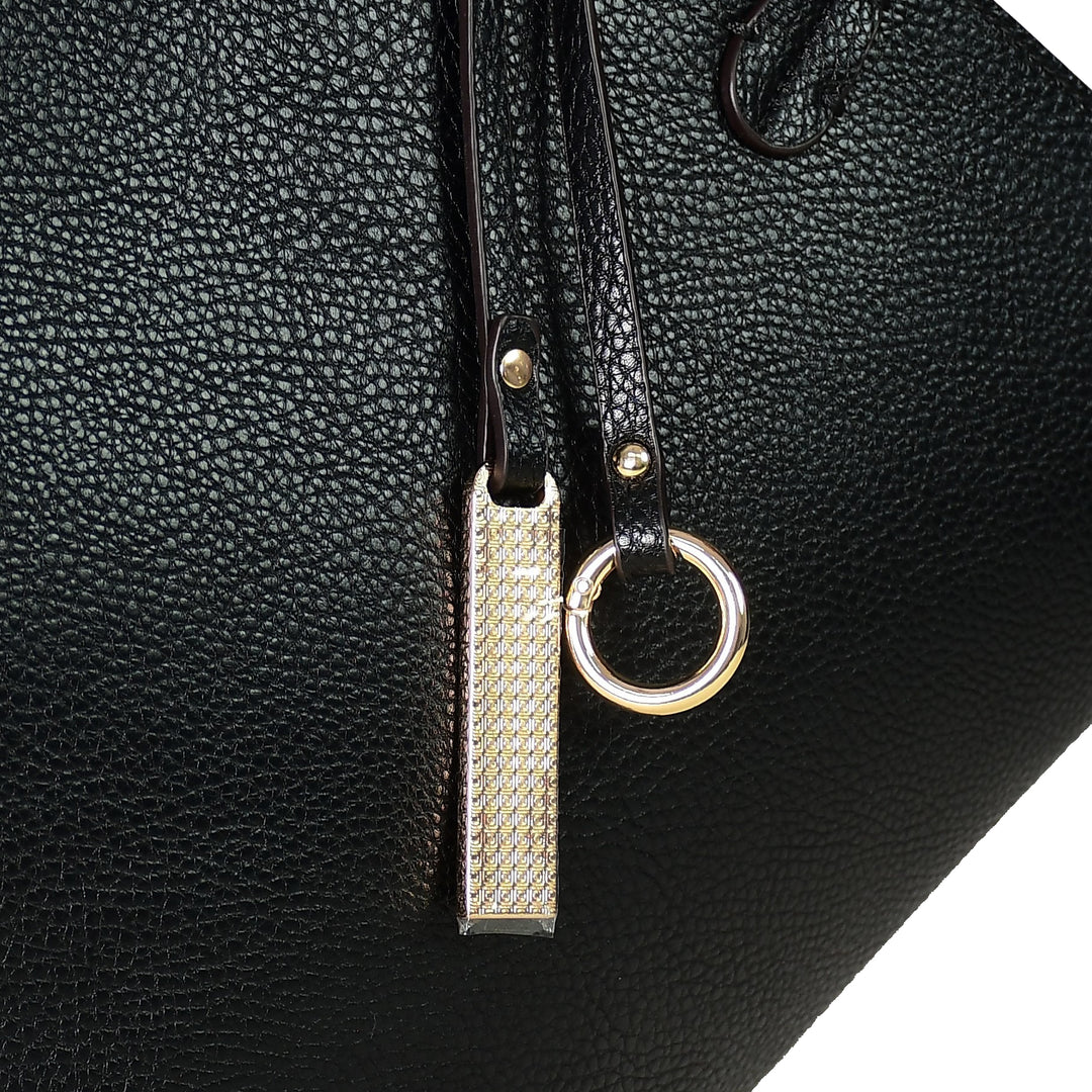 Black leather bag with a gold zipper pull and ring detail