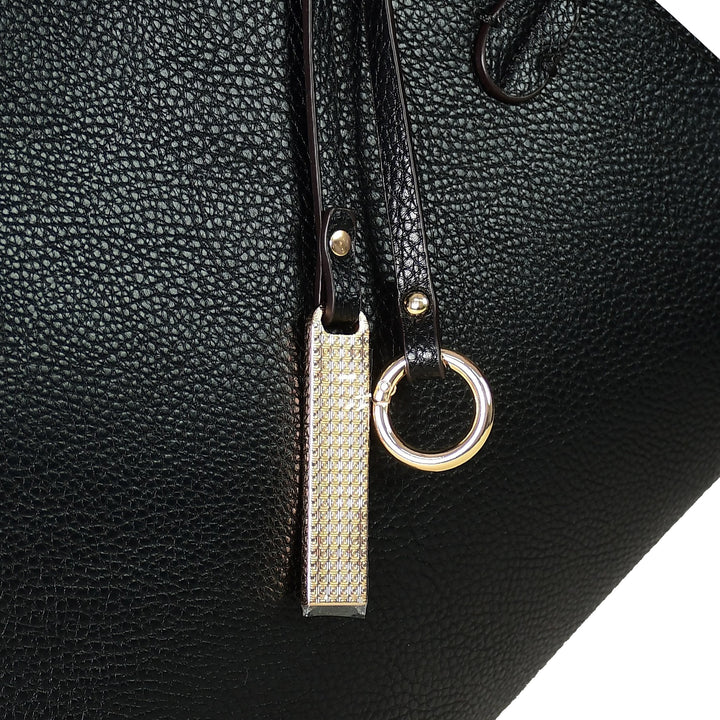 Black leather bag with a gold zipper pull and ring detail