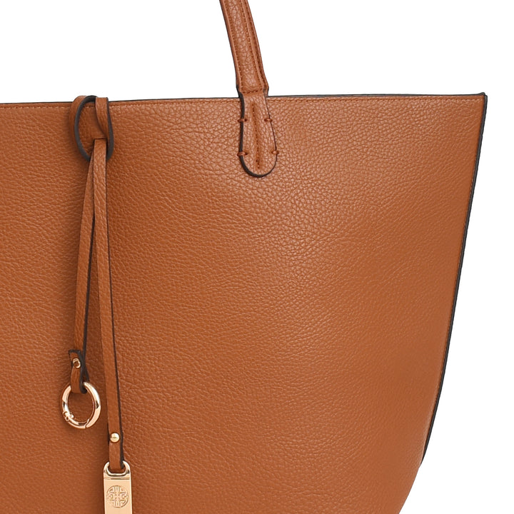 Brown leather tote bag with drawstring and metal tag on a white background