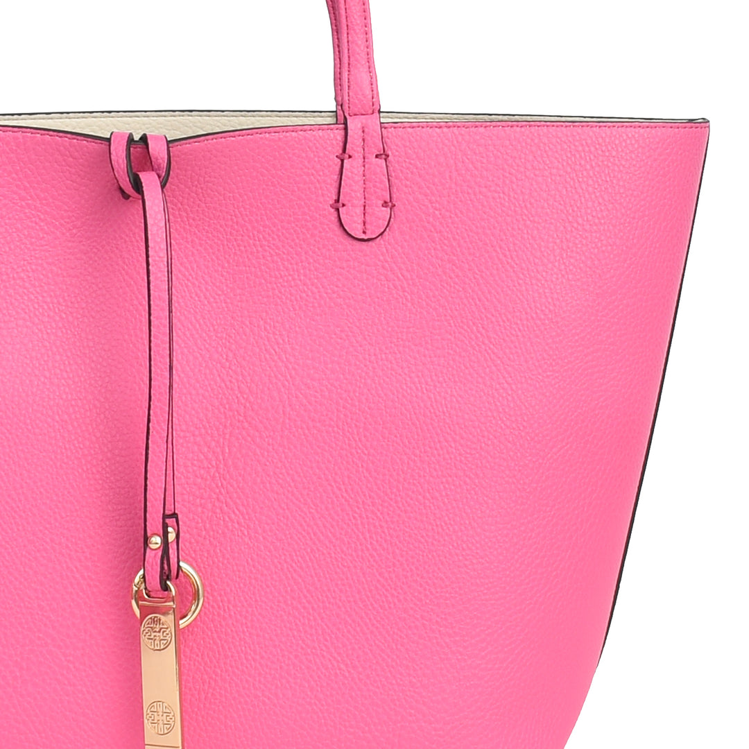 Close-up of a pink handbag with a gold tag on a white background