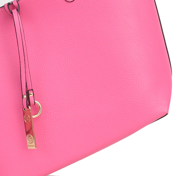 Close-up of a pink handbag with a gold tag on a white background