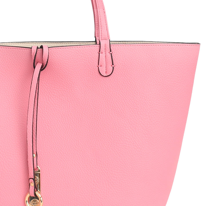 Close-up of a pink handbag with a strap and visible brand logo.