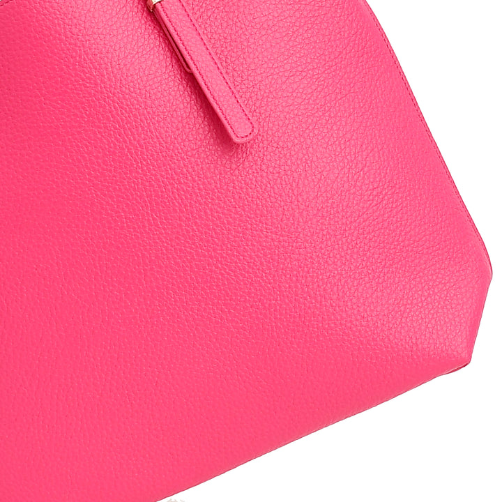 Close-up of a pink handbag with a textured surface on a white background