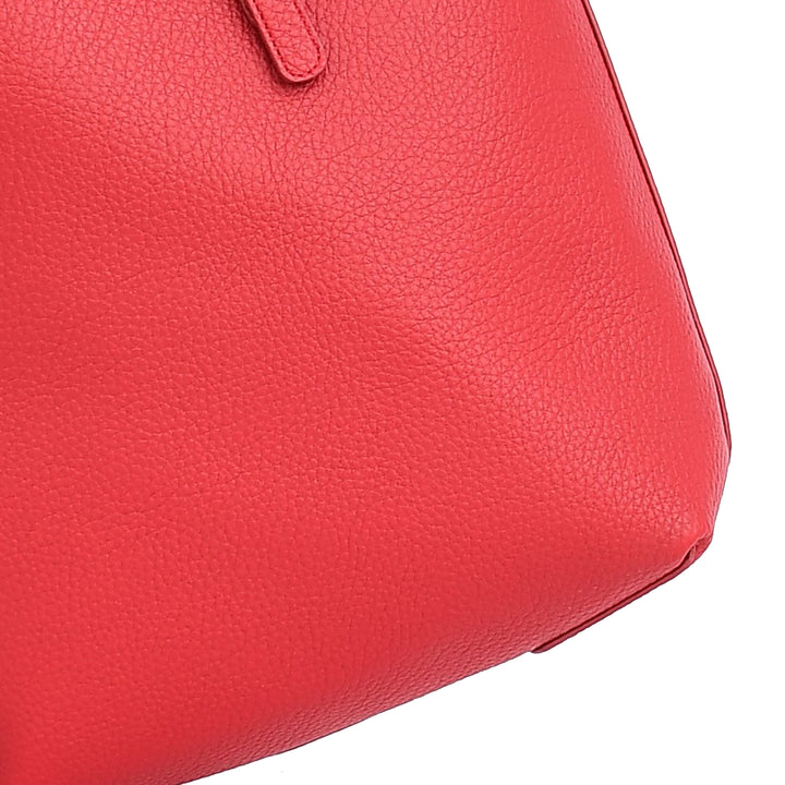 Close-up of a red handbag with a textured surface