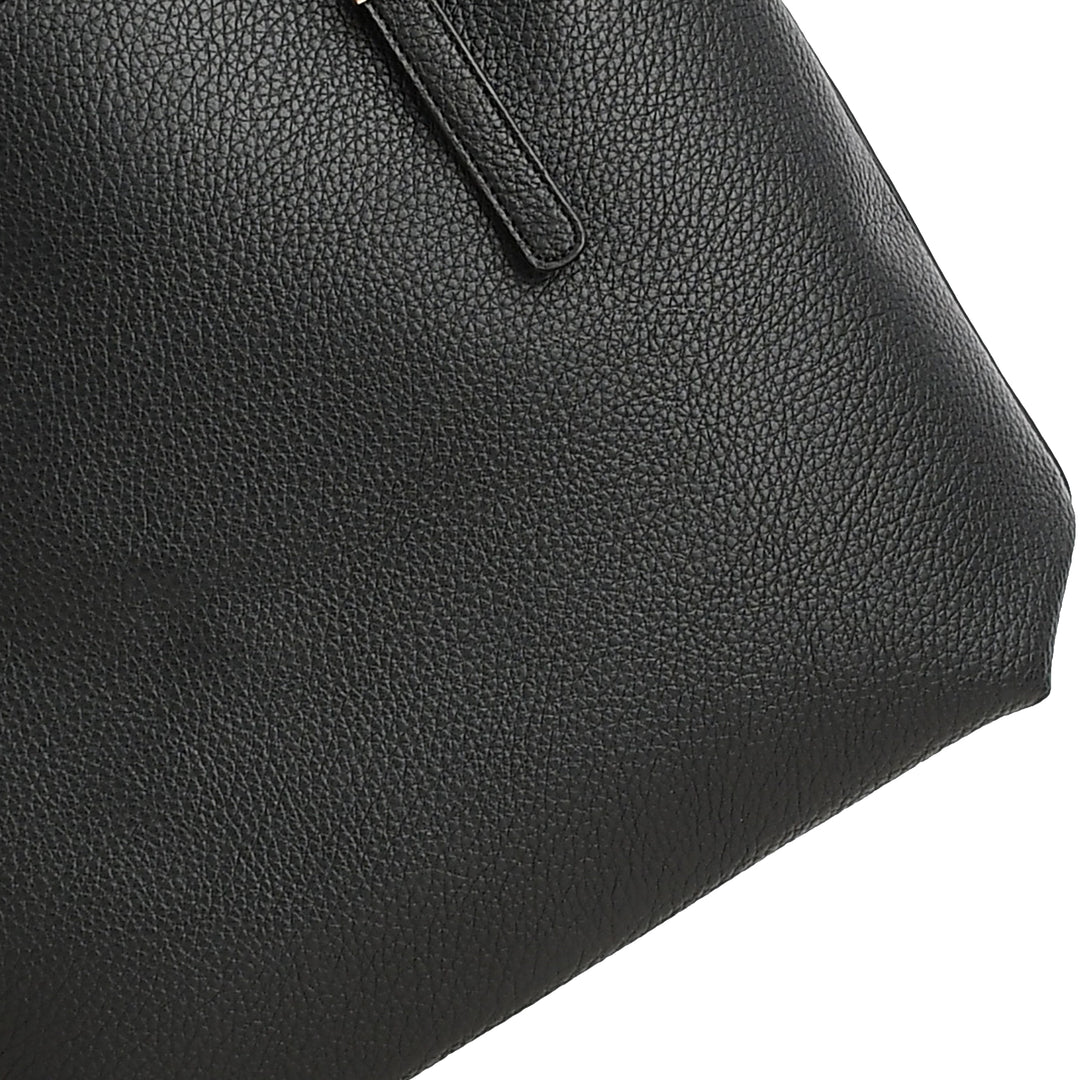 Close-up of a black leather handbag on a white background
