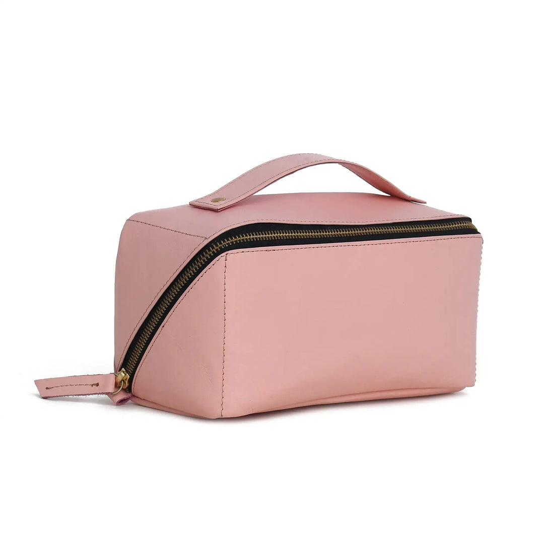 Pink toiletry bag with gold zipper on a white background