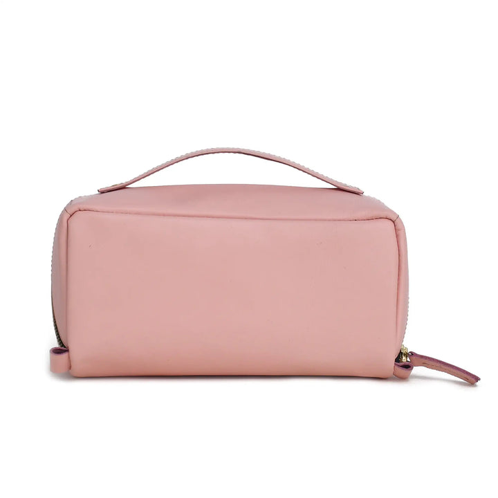 Pink leather toiletry bag with a handle on a white background