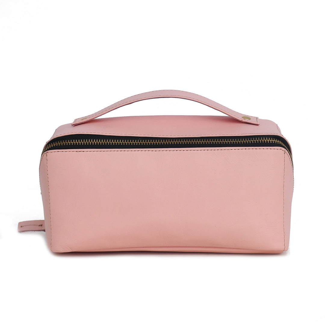 Pink toiletry bag with a handle on a white background