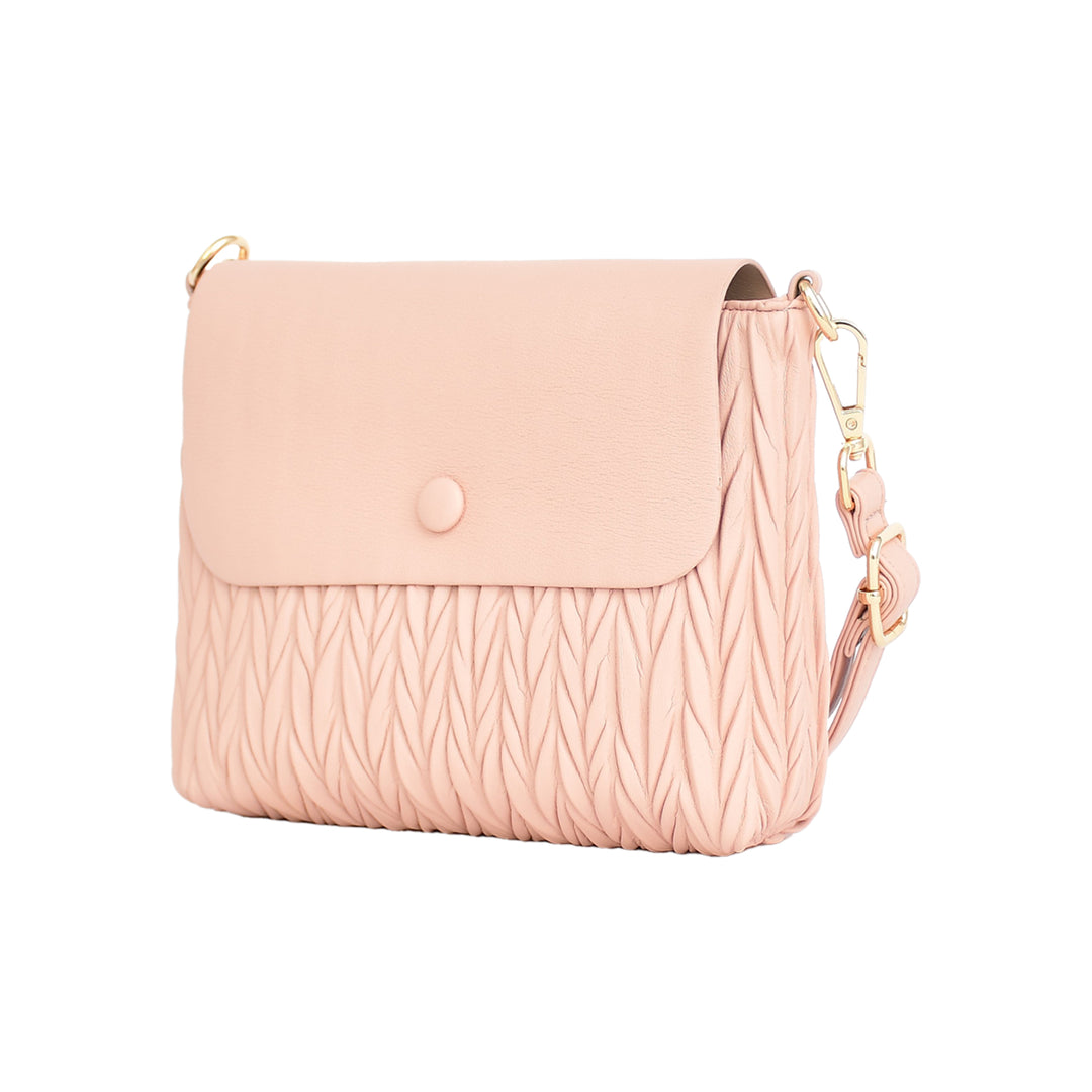 Pink crossbody bag with a textured pattern on a white background