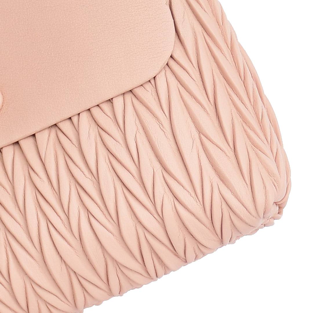 Close-up of a blush pink textured fabric with a white background