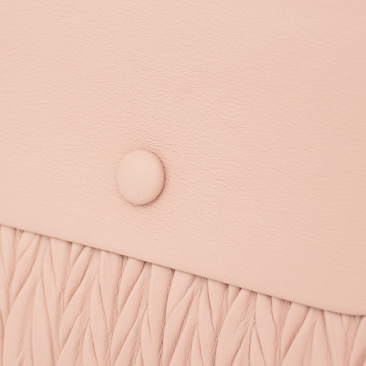 Pink crossbody bag with a textured pattern on a white background