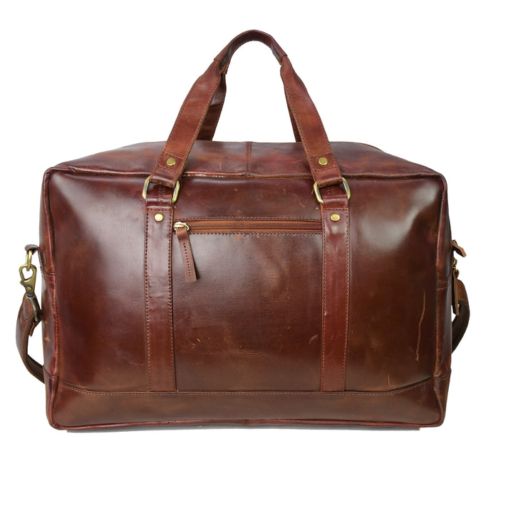 Brown leather duffel bag with gold hardware on a white background