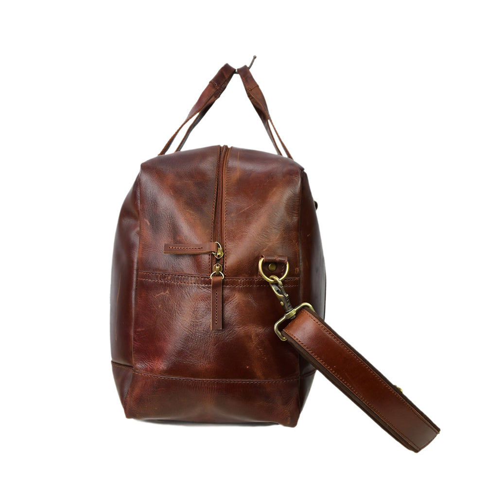 Brown leather backpack with gold zipper on a white background