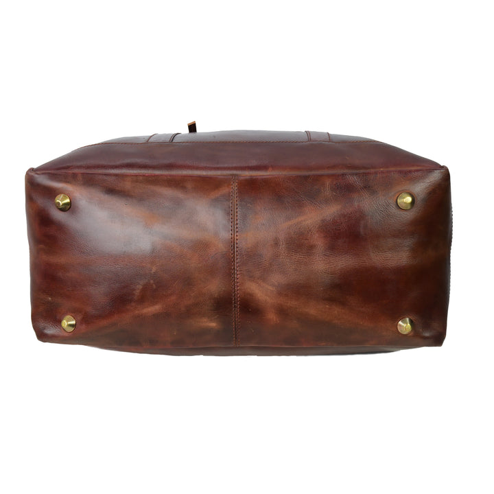 Brown leather bag with gold studs on a white background