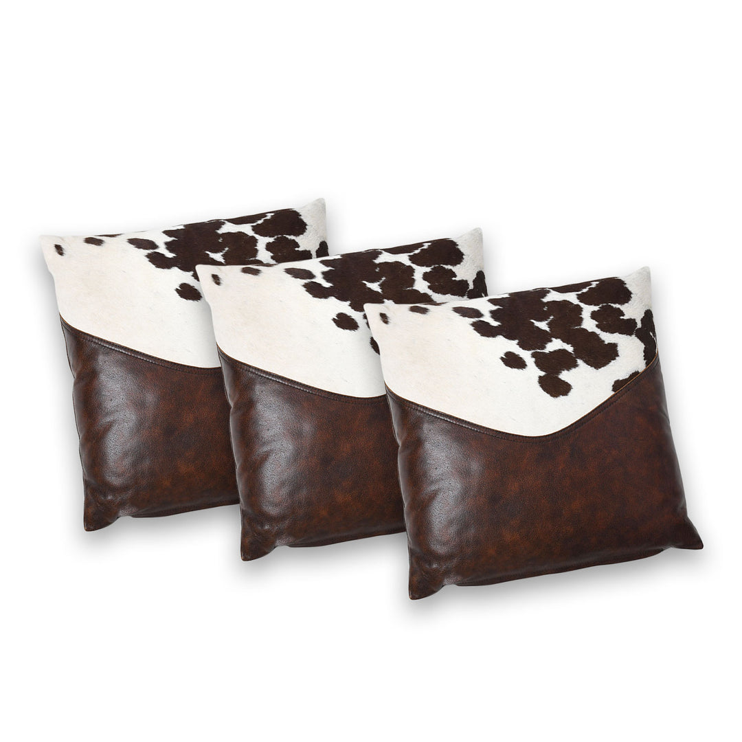 Three cowhide patterned pillows with brown and white