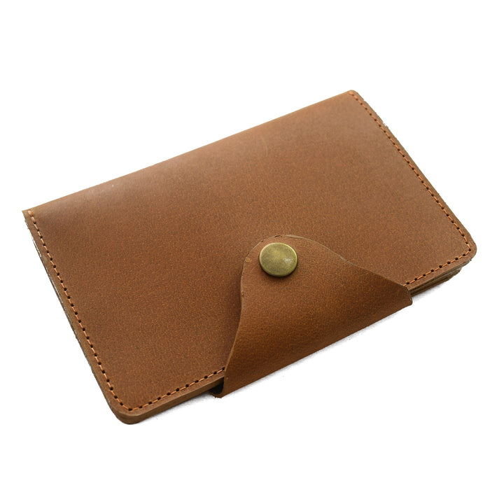 Brown leather cardholder with a green button on a white background