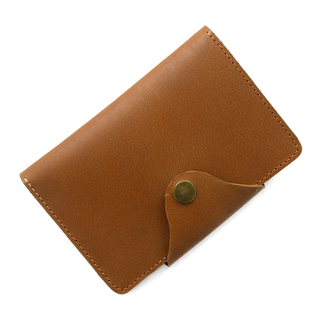 Brown leather wallet with a gold button on a white background