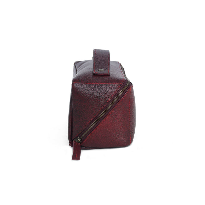 Red leather bag with a diagonal zipper on a white background