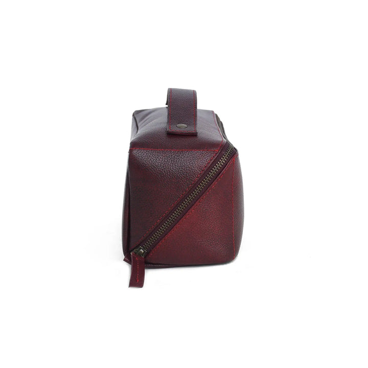 Red leather bag with a diagonal zipper on a white background