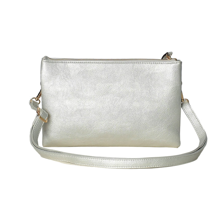 Silver metallic crossbody bag on a white background