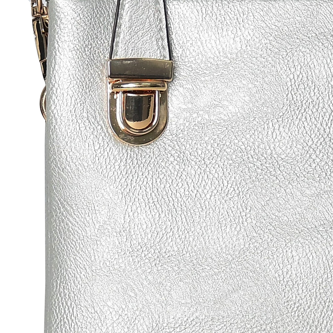 Close-up of a silver handbag with a gold clasp on a white background