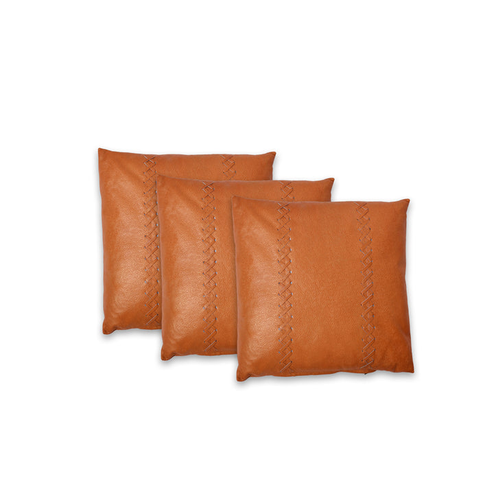 Three brown leather pillows with decorative stitching on a white background

