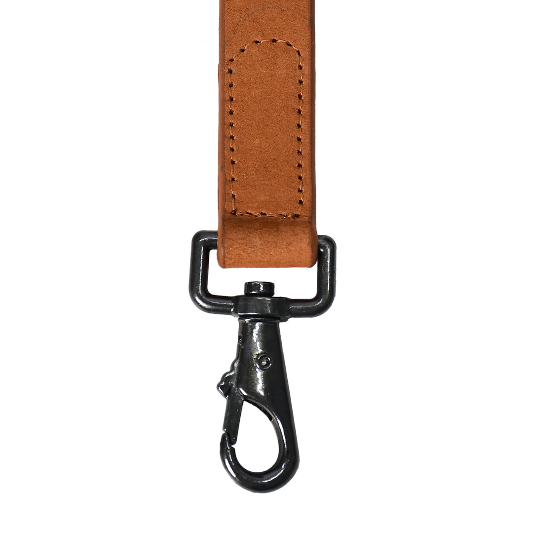 Brown leather strap with black metal clip on a white background

