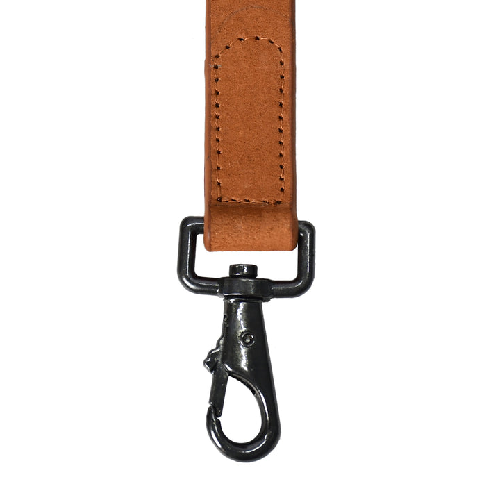 Brown leather strap with black metal clip on a white background

